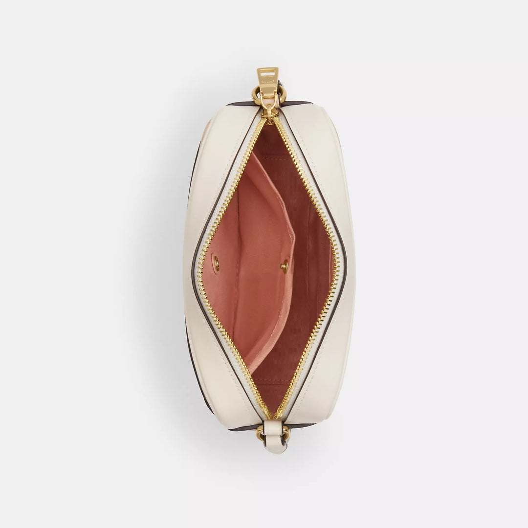 𝐂𝐎𝐀𝐂𝐇                     Bolso para cámara mini Jamie en lona de la firma con estampado floral. CO0025