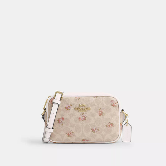 𝐂𝐎𝐀𝐂𝐇                     Bolso para cámara mini Jamie en lona de la firma con estampado floral. CO0025
